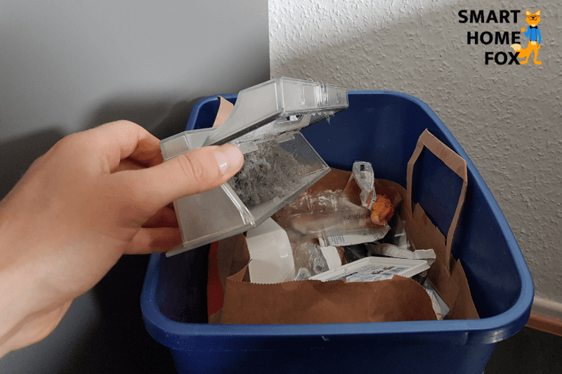 Emptying the Roborock S5 Max’s mobile dust container over a dustbin